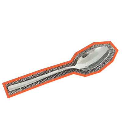 A metal spoon, with an orange outline placed at angle.